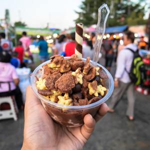 a hand holding a bowl of food